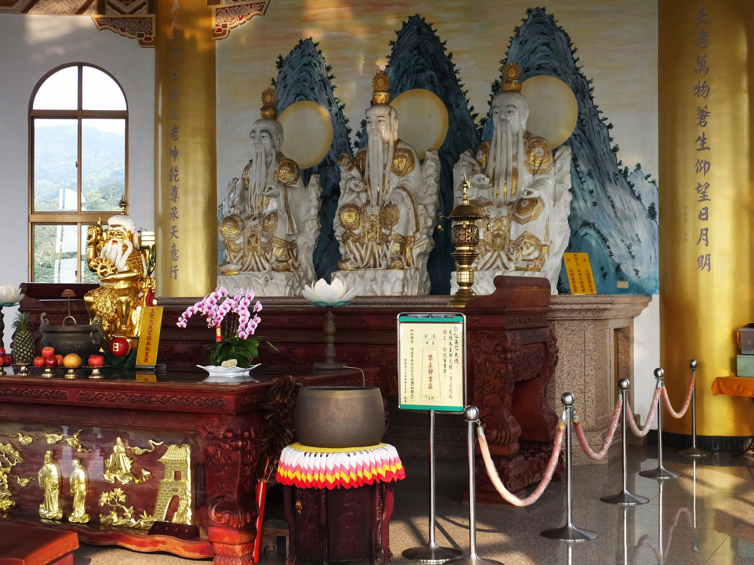 Three Pure Ones represented as seated statues in a Taoist temple hall